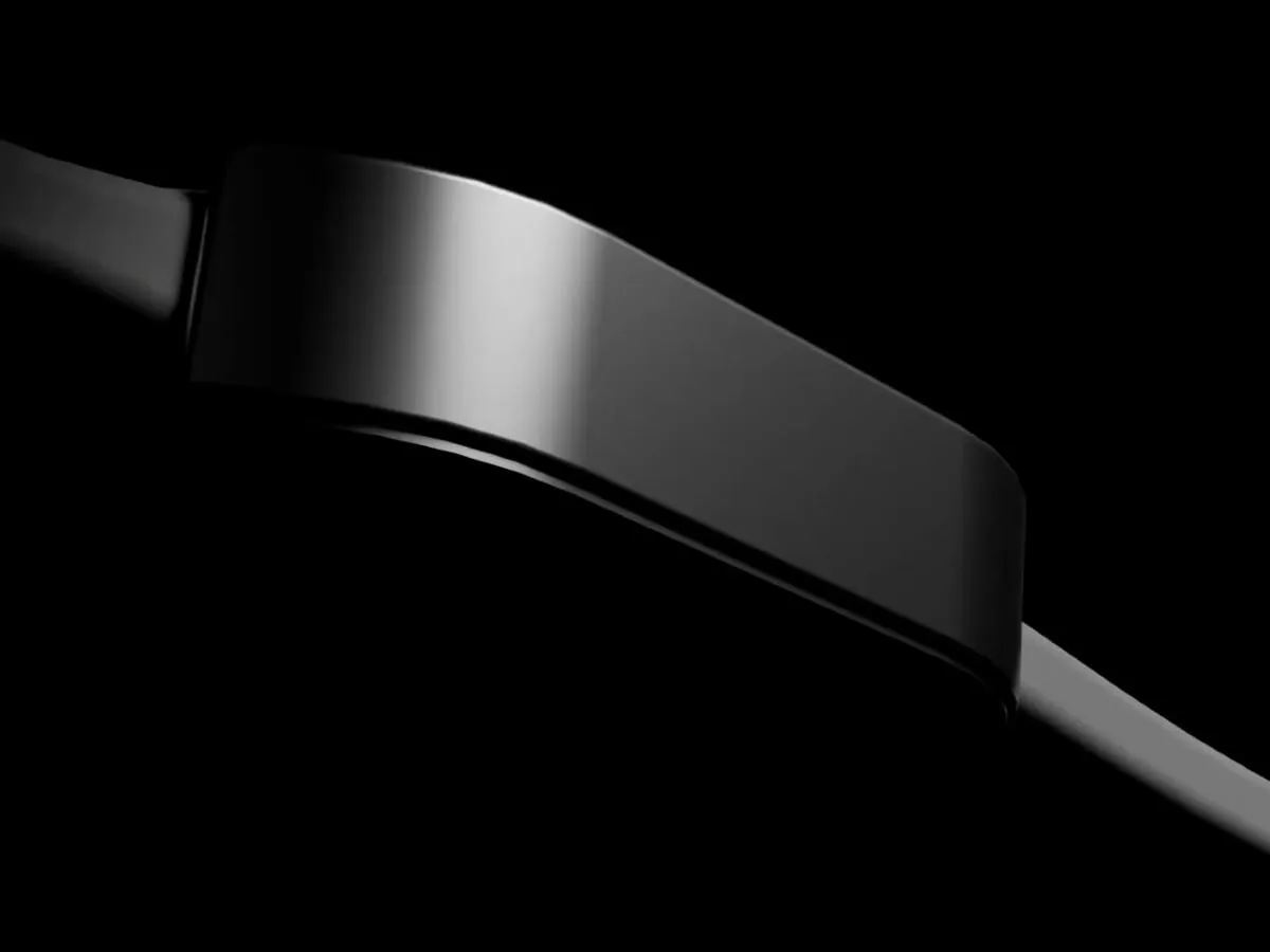 Render of the UnityBeat wristband, a slim black band with a glossy module, lit from the side against a black background